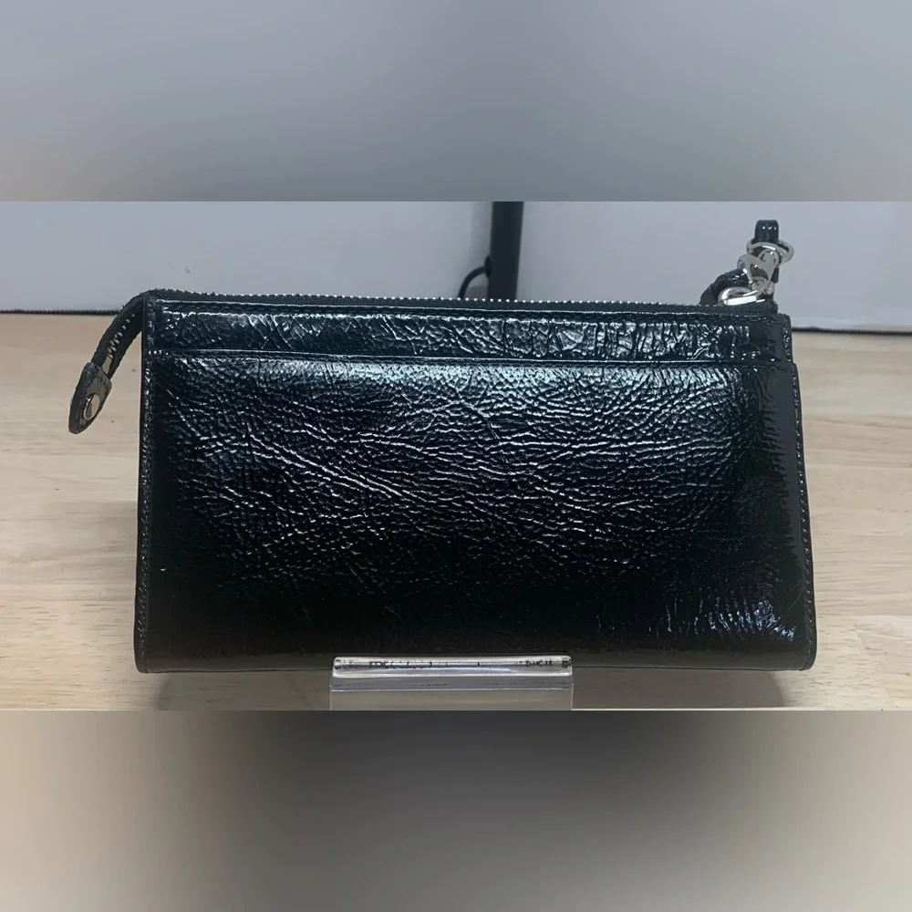 Coach Poppy Black patent leather wristlet with pink poppy interior.